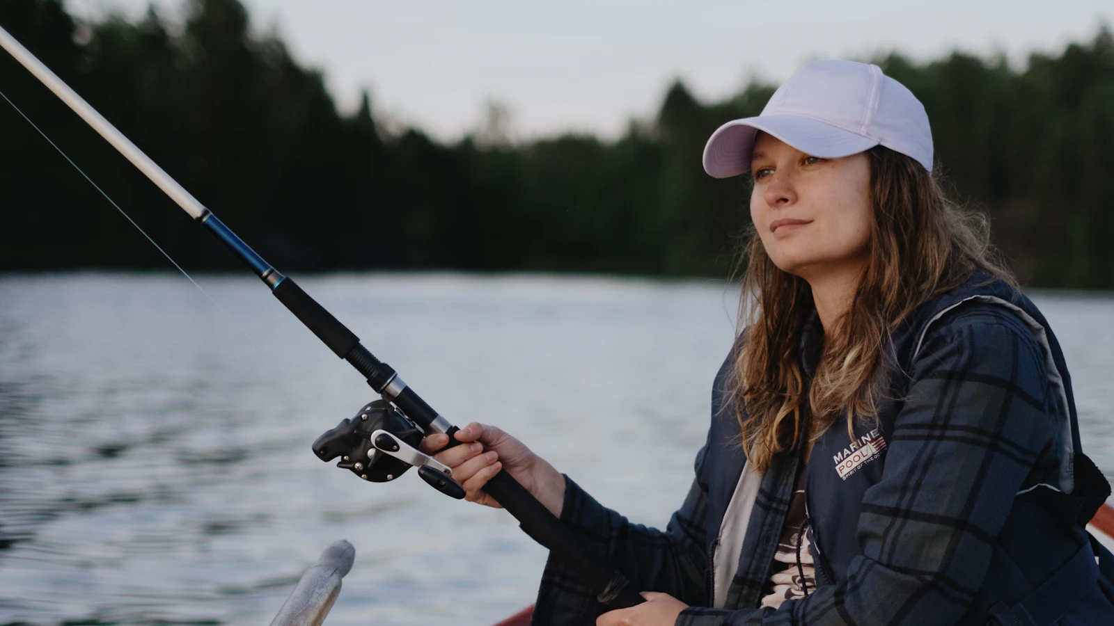 A woman fishing from a small boat, illustrating the example interview